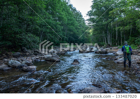 A man enjoying fishing in a mountain stream in summer in Hiedama Village, Fukushima Prefecture 133487020
