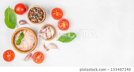Fresh cooking ingredients with tomatoes, garlic, basil and spices on white textured background with copy space 133487140