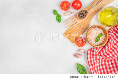 Fresh cooking ingredients and kitchen utensils on a white textured background with copy space Fresh cooking ingredients and kitchen utensils on a white textured background with copy space 133487142