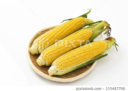 Silken corn on a colander on a white background 133487708
