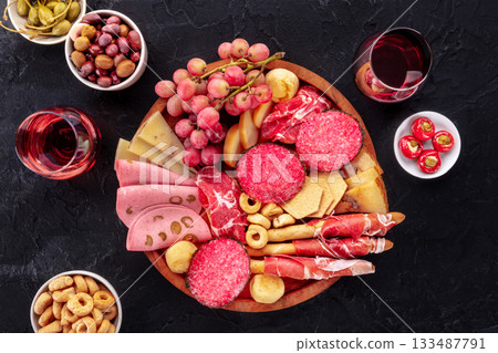 Italian Antipasti. Charcuterie platter with cheese and other snacks, with wine 133487791