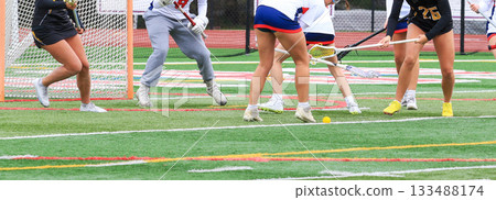 Female Lacrosse Players Engaging in a Competitive Match on the Field Female Lacrosse Players Engaging in a Competitive Match on the Field 133488174