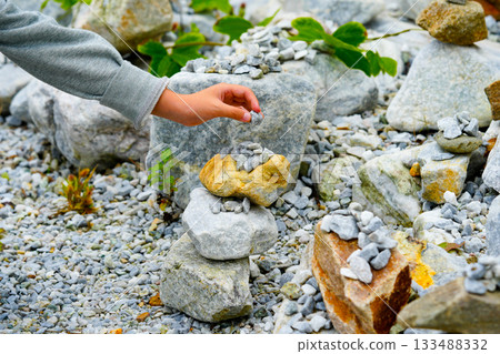 Relaxed spiritually child's hand arrangement pebble tower. Yoga relax meditation Relaxed spiritually child's hand arrangement pebble tower. Yoga relax meditation 133488332