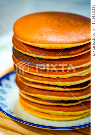 Freshly tasty stack of pancakes on the plate. Delicious homemade breakfast Freshly tasty stack of pancakes on the plate. Delicious homemade breakfast 133488335