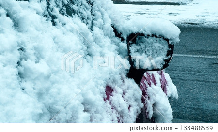 Snow covered car mirror and door during early winter weather Snow covered car mirror and door during early winter weather 133488539