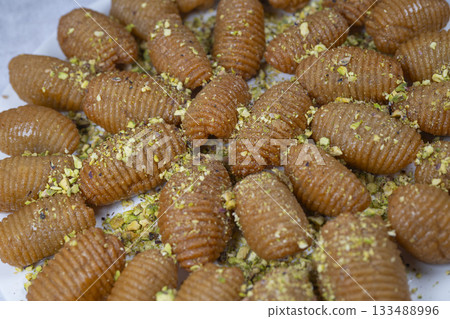 Lebanese recipe for Maakaroun fritters: fine wheat semolina, flour, butter, oil, ground anise Lebanese recipe for Maakaroun fritters: fine wheat semolina, flour, butter, oil, ground anise 133488996