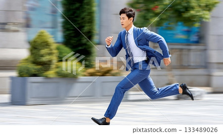 young business man in suit running in the city 133489026