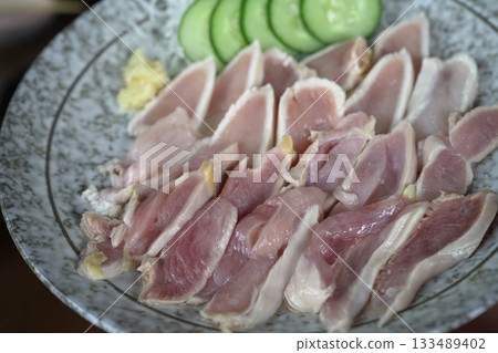 Kagoshima specialty: Fresh seared local chicken (local chicken sashimi) with cucumber and ginger Kagoshima specialty: Fresh seared local chicken (local chicken sashimi) with cucumber and ginger 133489402