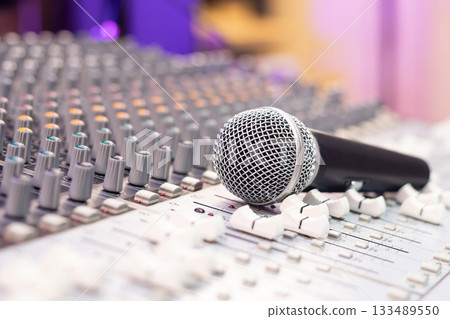 dynamic microphone on audio mixing console. singing, recording concept dynamic microphone on audio mixing console. singing, recording concept 133489550