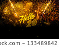 A new year card with the bright golden fireworks in the night sky and the golden letters Hello 26 on black background. 133489842