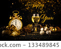 Happy New Year greeting card with golden alarm clock shows midnight time and  shampagne glass on dark background. 133489845