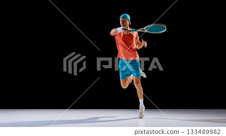 Tennis player running forward to return ball with full determination Tennis player running forward to return ball with full determination 133489982