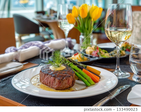 Gourmet grilled steak with cherry tomatoes, green beans, and rich sauce on a white plate Gourmet grilled steak with cherry tomatoes, green beans, and rich sauce on a white plate 133490023