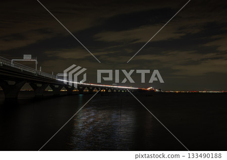 Tokyo Bay Aqua-Line and Umihotaru night view and light trails seen from Kisarazu City, Chiba Prefecture 133490188