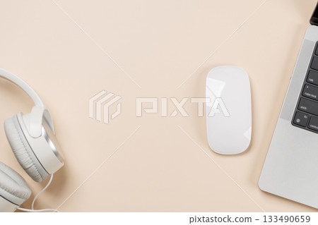 Laptop and stationery on beige workspace, top view with copy space 133490659
