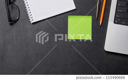 Office supplies and laptop on black leather workspace, top view with copy space Office supplies and laptop on black leather workspace, top view with copy space 133490666