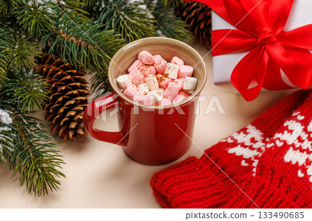 Cup with marshmallows, snowy fir branches 133490685