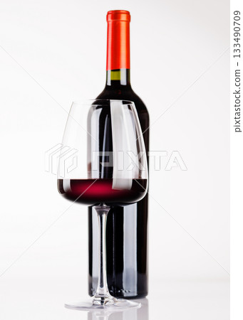 Red wine bottle and glass on white background Red wine bottle and glass on white background 133490709