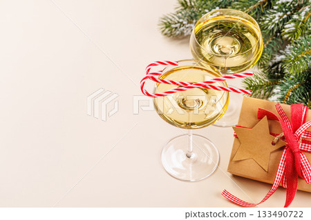 Champagne glasses and snowy fir branches Champagne glasses and snowy fir branches 133490722