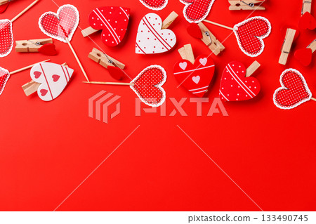 Various heart-shaped decorations arranged on a red background with ample copy space Various heart-shaped decorations arranged on a red background with ample copy space 133490745
