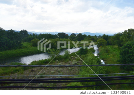 View of the area between stations from Asahikawa Station on the JR Hokkaido Furano Line (early morning in summer 2023) View of the area between stations from Asahikawa Station on the JR Hokkaido Furano Line (early morning in summer 2023) 133490981