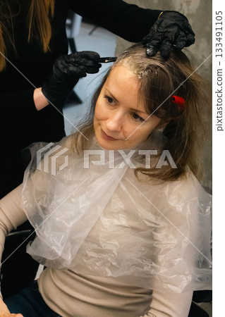 Woman with brown hair changing hair style. Beauty transformation. Hair dye concept. Natural women beauty. Hair colouring in beauty salon. Bride preparing for wedding. Hairstyle concept.  133491105