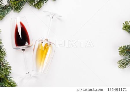 Wine glasses with fir branches on white background Wine glasses with fir branches on white background 133491171