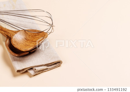 Kitchen utensils on beige table Kitchen utensils on beige table 133491192