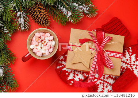 Gift box, cup with marshmallows, snowy fir branches Gift box, cup with marshmallows, snowy fir branches 133491210