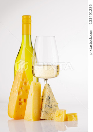 Assorted cheeses and wine on white background Assorted cheeses and wine on white background 133491226