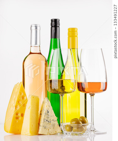 Assorted cheeses and wine on white background 133491227