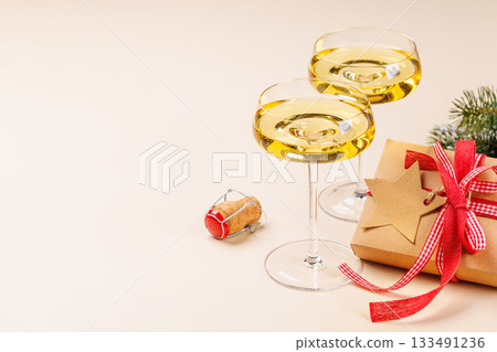 Champagne glasses and snowy fir branches 133491236