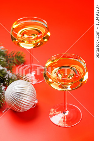 Champagne glasses and snowy fir branches 133491237