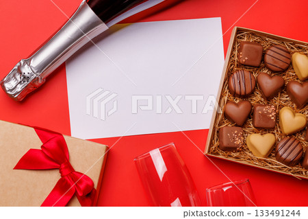 A glasses of champagne elegantly paired with a box of rich chocolates 133491244