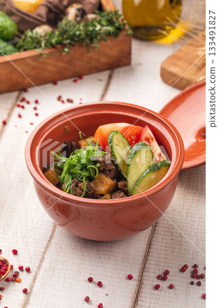Rustic clay pot with stewed meat potatoes vegetables Rustic clay pot with stewed meat potatoes vegetables 133491827