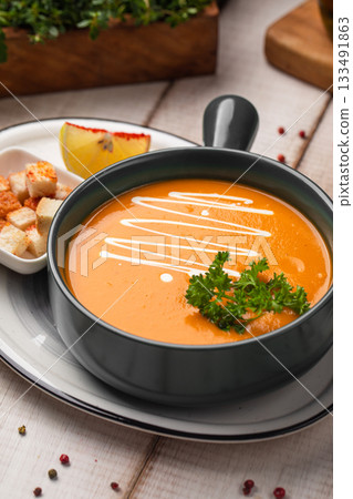 Creamy pumpkin soup with croutons garnish Creamy pumpkin soup with croutons garnish 133491863