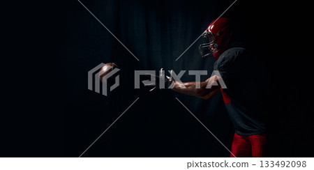 Football player reaching forward for ball with intense emotional urgency. Banner 133492098