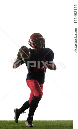 American football player jumping with triumphant emotion holding ball isolated on white background 133492133