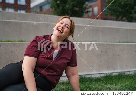 Sporty woman resting, drinking water after training. Sporty woman resting, drinking water after training. 133492247