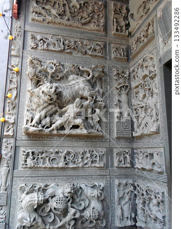 A Dramatic Stone Carving Depicting a Lion in Combat with Surrounding Mythical Reliefs A Dramatic Stone Carving Depicting a Lion in Combat with Surrounding Mythical Reliefs 133492286