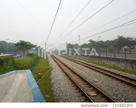 Foggy Railway Tracks Leading into the Distance 133492303