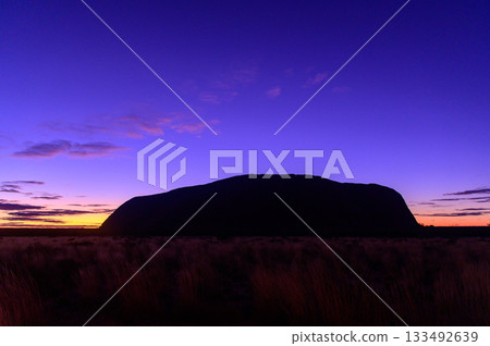 A beautiful view of Ayers Rock floating in the night sky just before sunrise 133492639