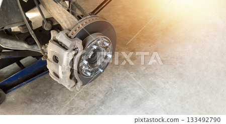 Removal of front wheel bearing on a passenger car. Dirty loud and rusty bearing in a front hub. Dismantling of a hub. Removal of front wheel bearing on a passenger car. Dirty loud and rusty bearing in a front hub. Dismantling of a hub. 133492790