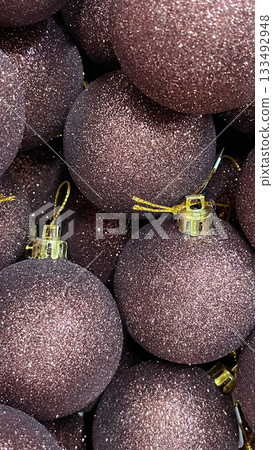 Heap of dark mauve glitter Christmas baubles close up. Festive holiday abstract background texture Heap of dark mauve glitter Christmas baubles close up. Festive holiday abstract background texture 133492948