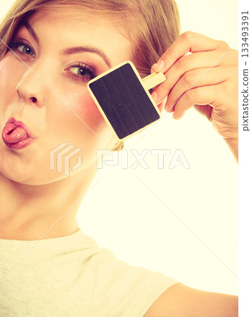 Teenage girl holding little school blackboards 133493391
