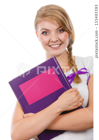 Young teenage student with braid holding books 133493393