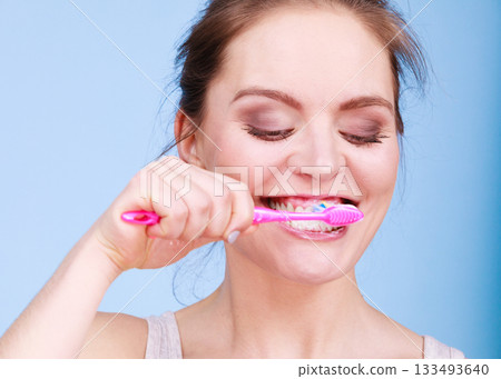 Woman brushing cleaning teeth 133493640