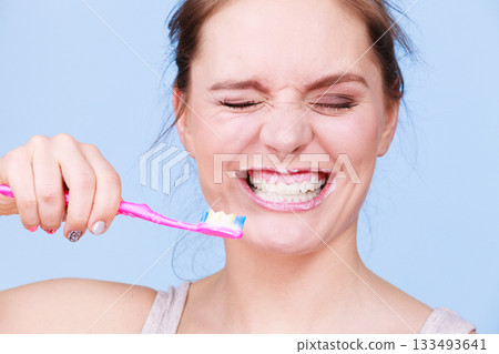 Woman brushing cleaning teeth 133493641
