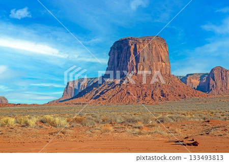 Monument Valley desert butte under blue sky Monument Valley desert butte under blue sky 133493813