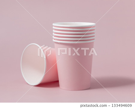Disposable light pink paper cups closeup, mockup, copy space. No plastic biodegradable single-use 133494609